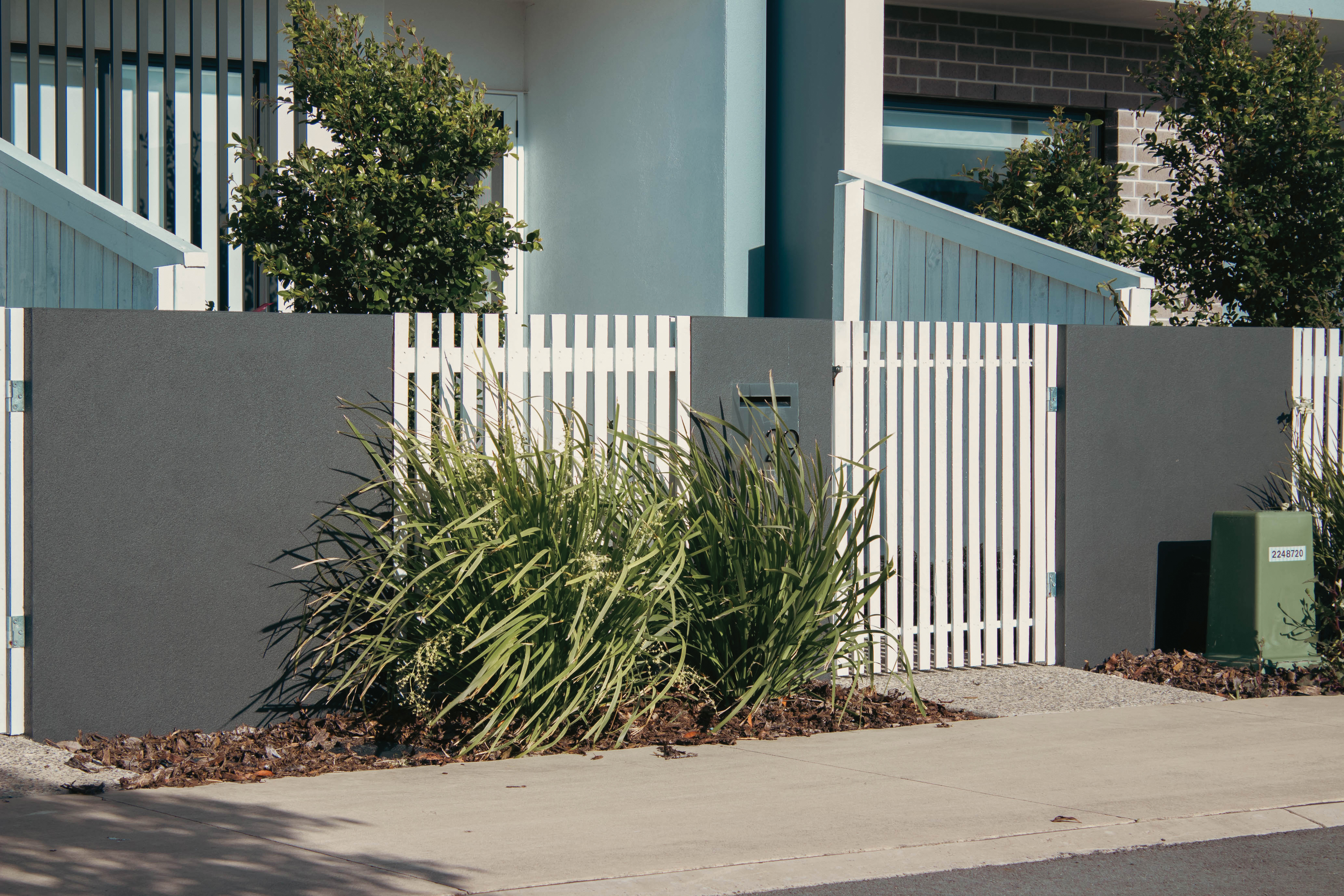 White picket fence outside of townhouse