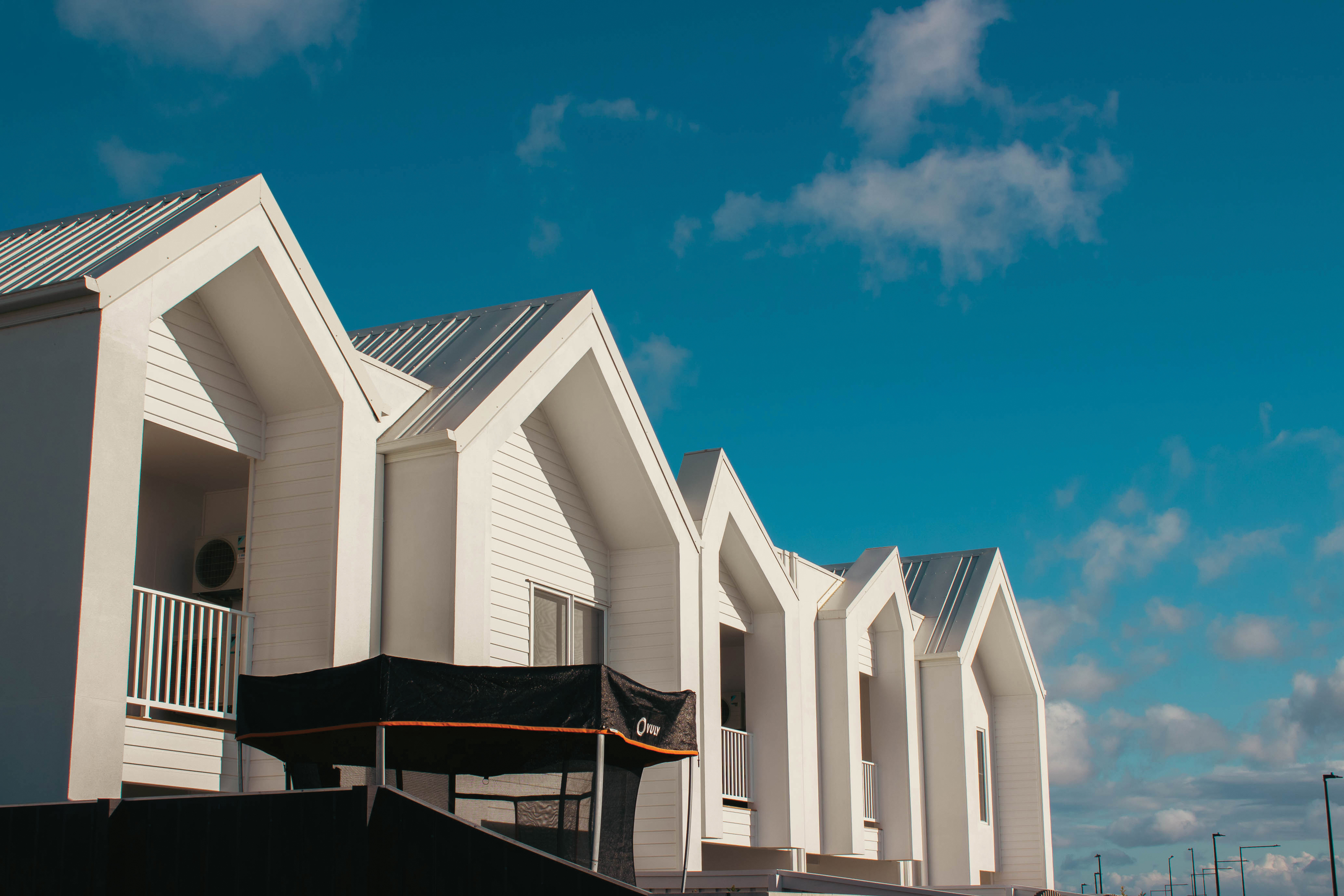 Roofs of townhouses with a blue sky and clouds