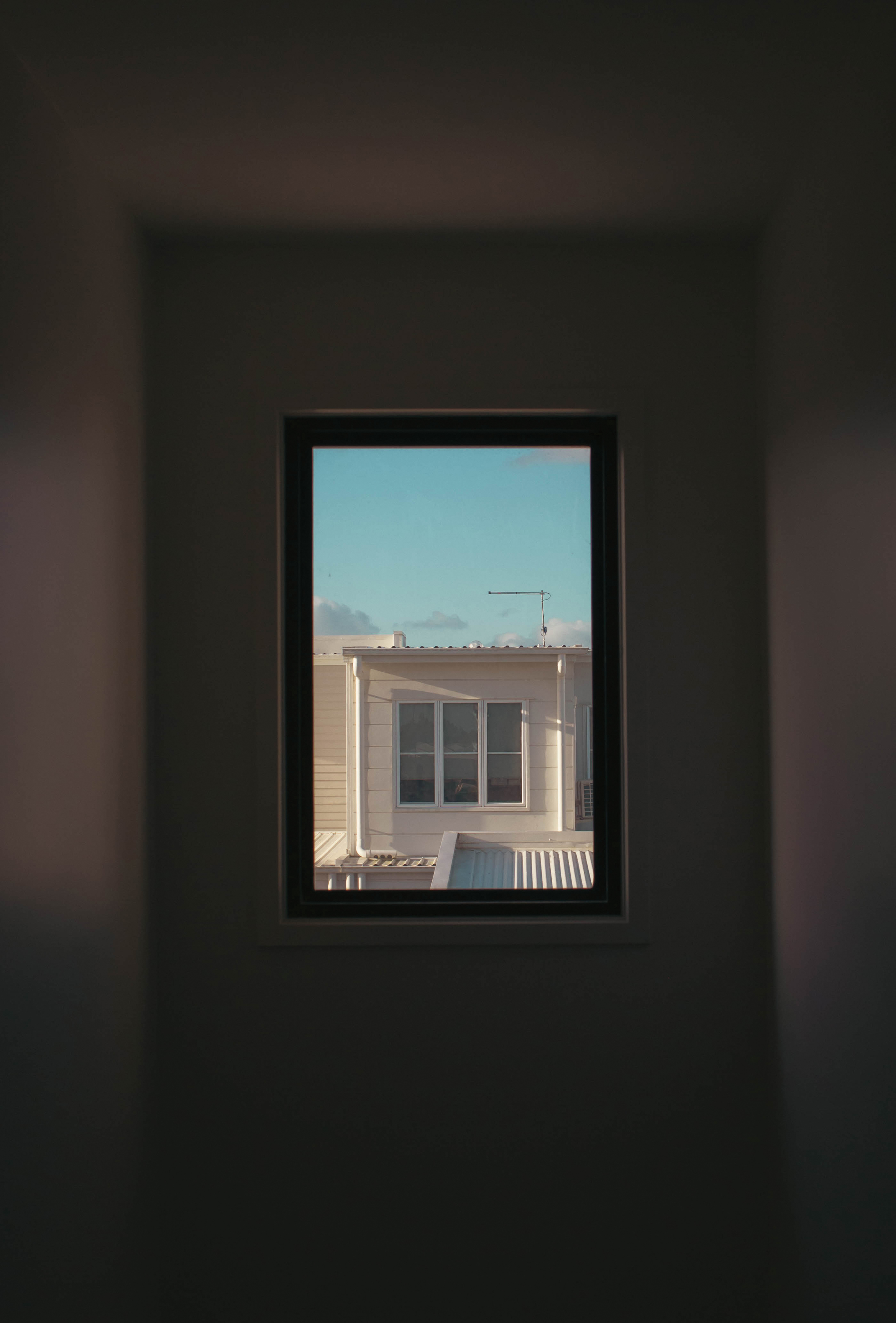 Window at top of stairs with view of house